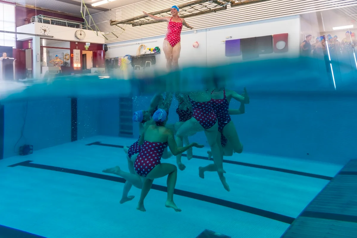 Synchronschwimmerinnen führen eine Hebefigur auf.